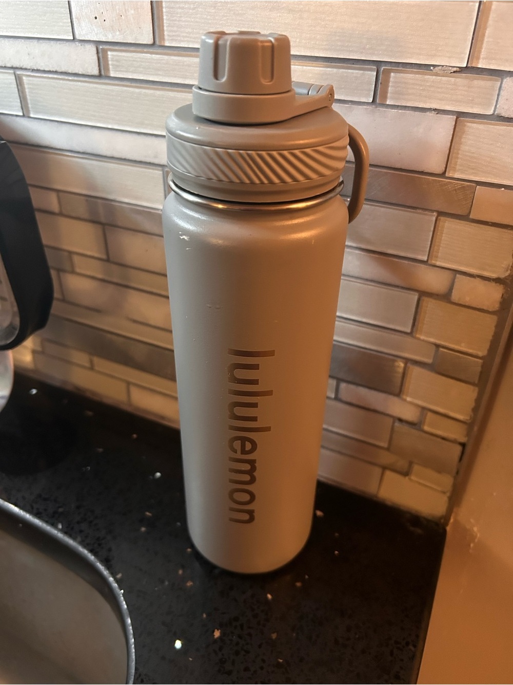 One gray lululemon water bottle metal screw on cap 120z